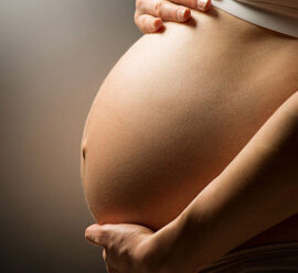 Heavily pregnant woman's baby bump.
